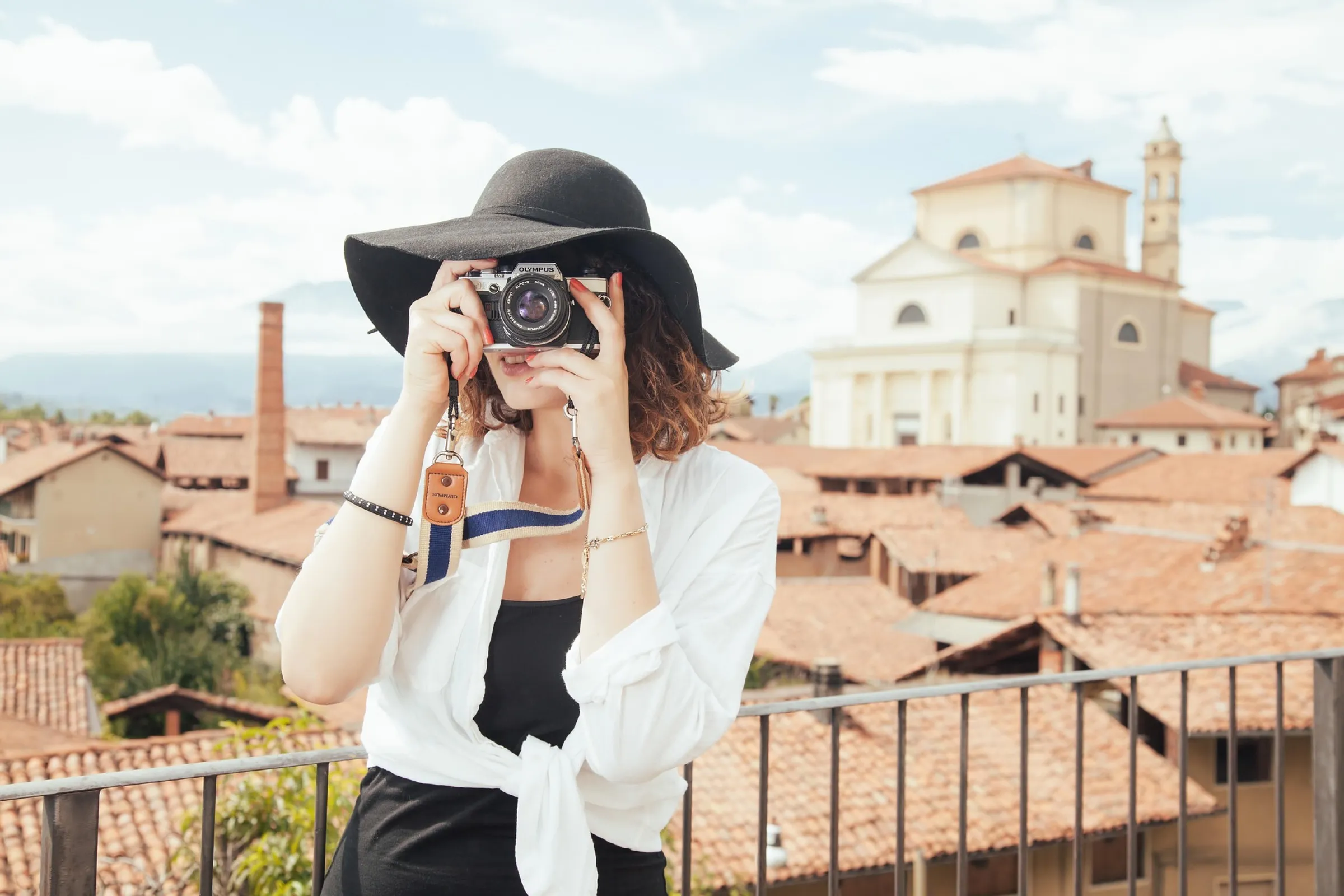 A traveler photographing rooftops from a viewpoint